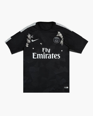 Close-up of the hand-embroidered pale grey blossom on the PSG football shirt — CRID