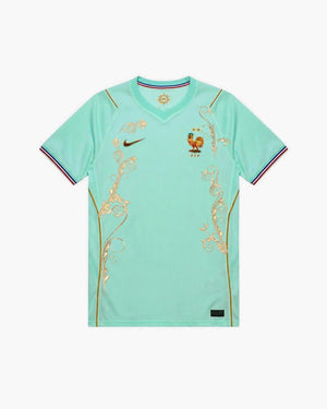 Close-up of the hand-embroidered gold scrollwork and flowers on the France football shirt — CRID