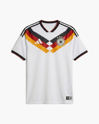 Germany 2026 home football shirt by adidas, white with a black, red and gold chevron across the chest, the DFB crest with four stars and the adidas logo, front view — CRID