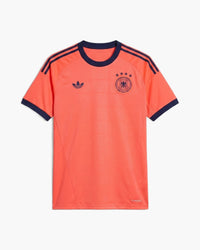 Germany 2026 goalkeeper football shirt by adidas Originals, coral with navy trim, the DFB crest with four stars and the trefoil, front view — CRID