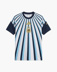 Argentina 2026 pre-match football shirt by adidas, white with light-blue and navy sunburst stripes, navy sleeves, the gold adidas logo and the gold AFA crest with three stars, front view — CRID