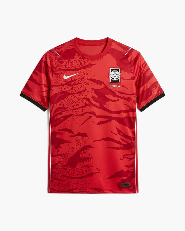 South Korea 2026 home football shirt by Nike, red with a tonal tiger-stripe camouflage, the white Swoosh and the KFA tiger crest above KOREA, front view — CRID