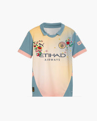 Manchester City hand-embroidered football shirt in blue / peach, front view — CRID